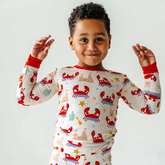 Boy posing in Beach Buddies printed two piece pajama set.