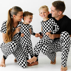 Family of four wearing matching Cool Checks printed pajama sets