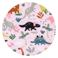 Image of two young children in coordinating long sleeve pajama pant sets in Jurassic Jungle print. This print features an all over repeat pattern of various dinosaurs in a navy or pink background.