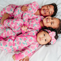 Siblings matching in Sweet Strawberries printed pajamas.