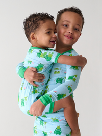 Sibling matching pajamas in Leaping Love print.