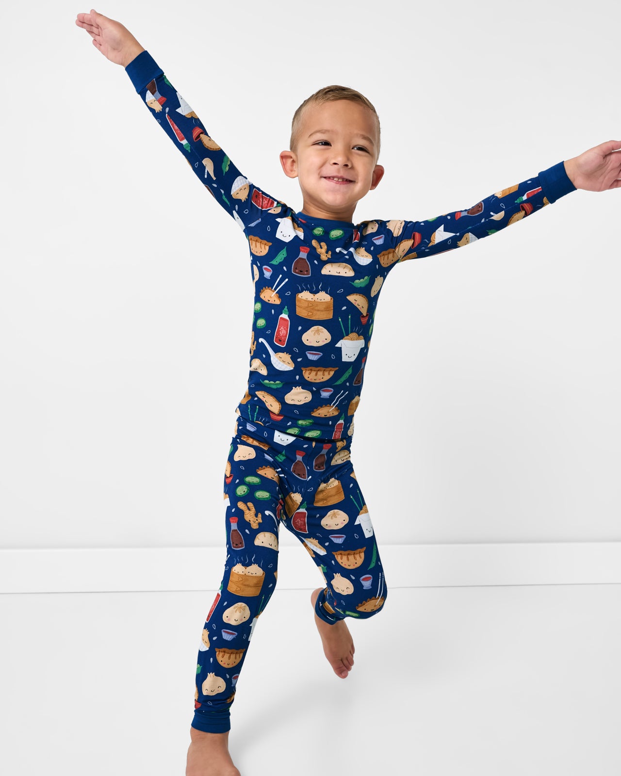 Child in motion wearing the Bao Buddies Two-Piece Pajama Set