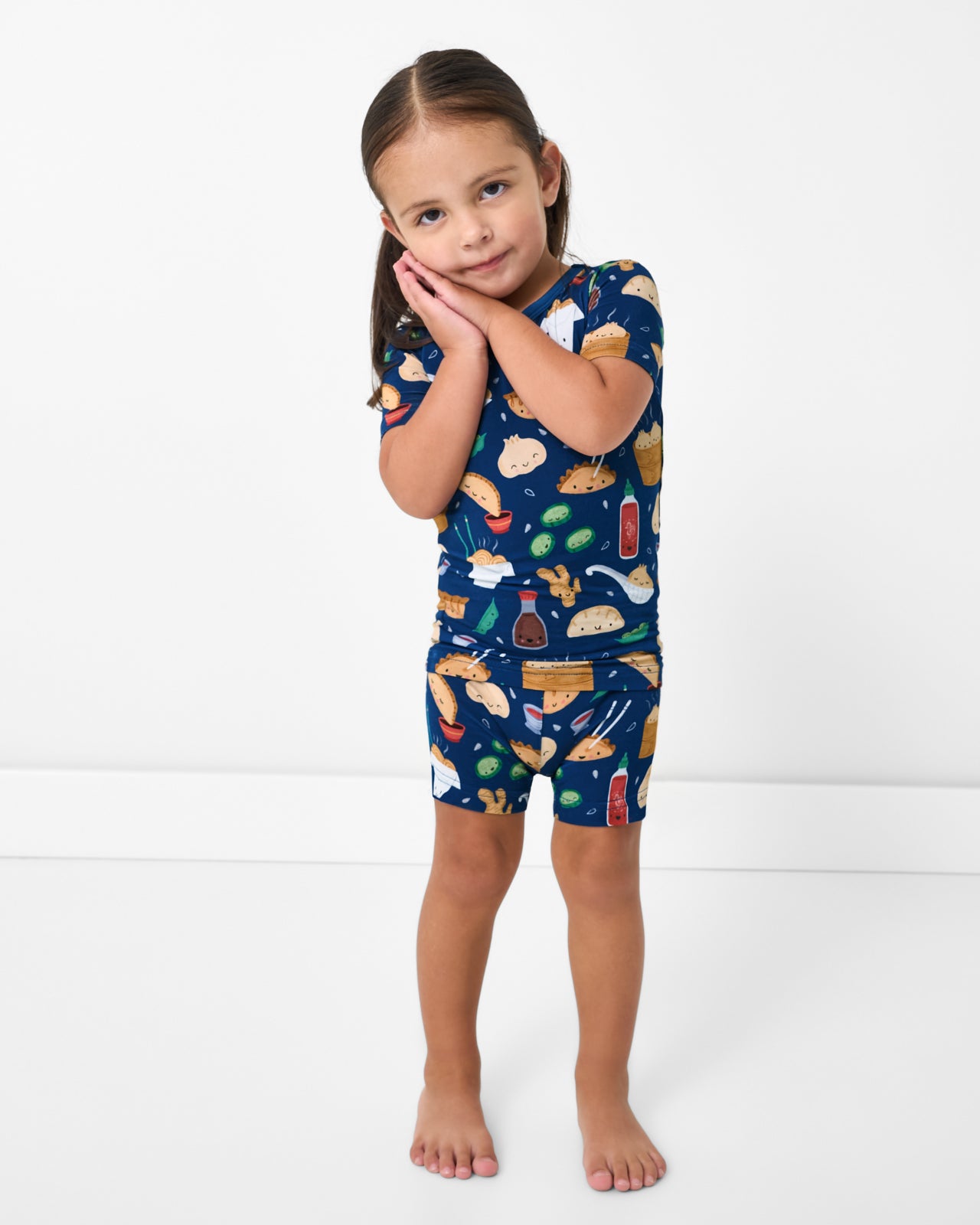 Standing girl wearing the Bao Buddies Two-Piece Short Sleeve & Shorts Pajama Set