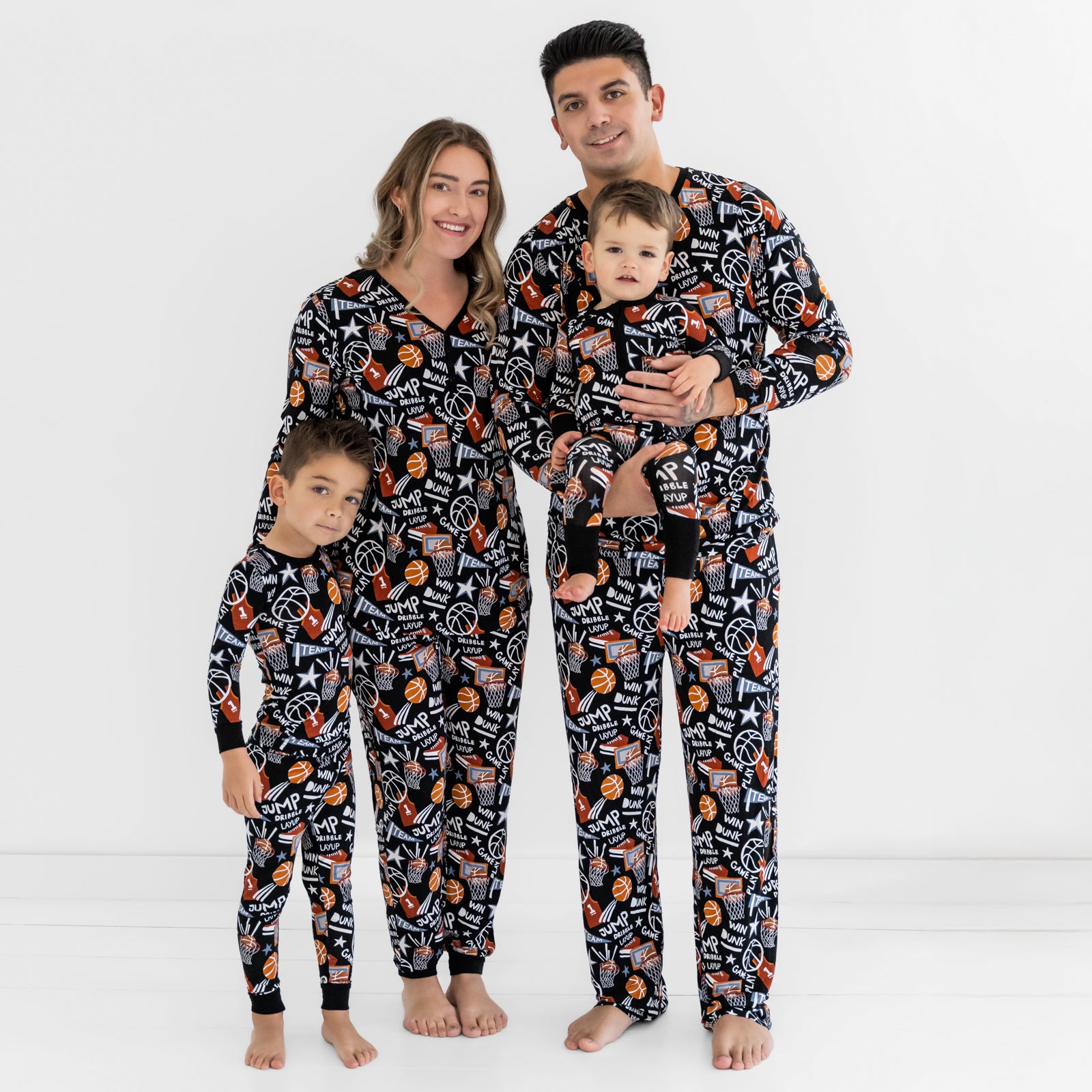 Family of four wearing matching Black Slam Dunk pajamas
