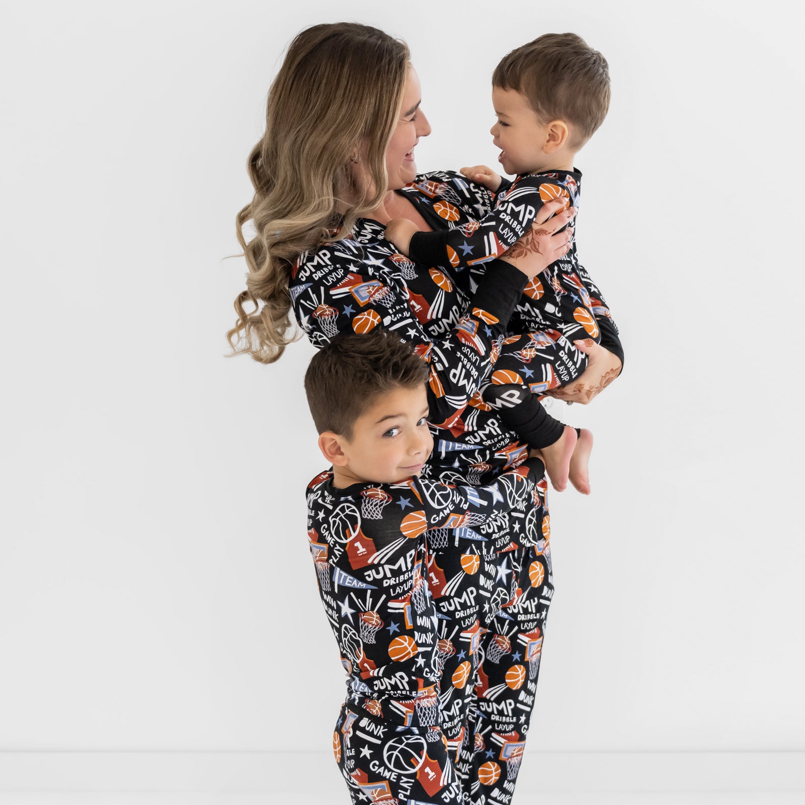 Mother and two children wearing matching Black Slam Dunk bamboo pajamas