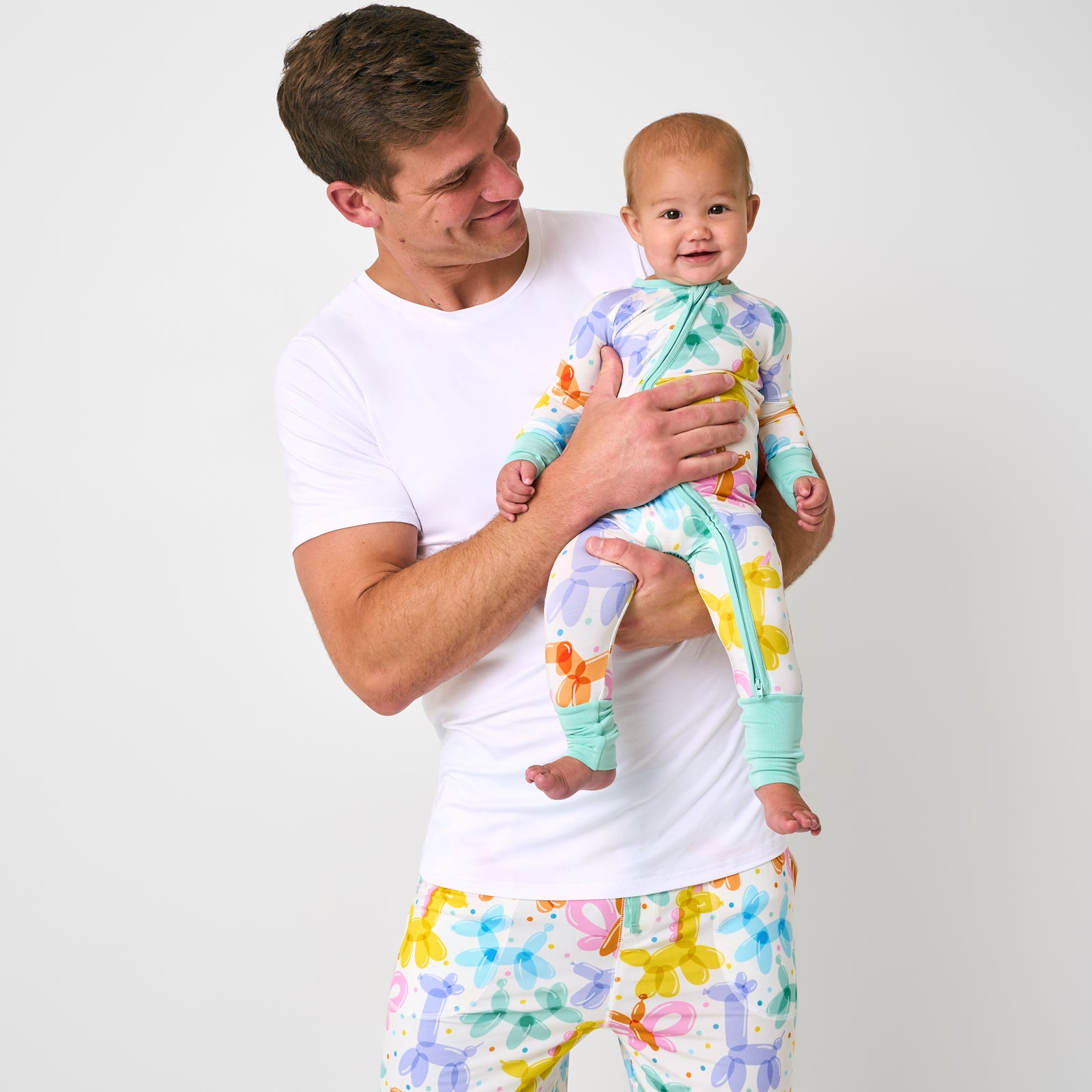 Father and child wearing matching Balloon Bash pjs