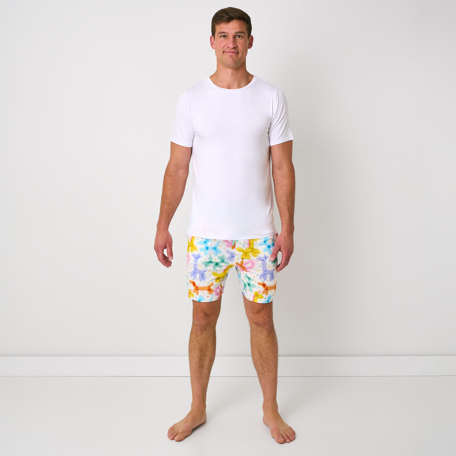 Standing man wearing the Balloon Bash Men's Pajama Shorts with a white pj top