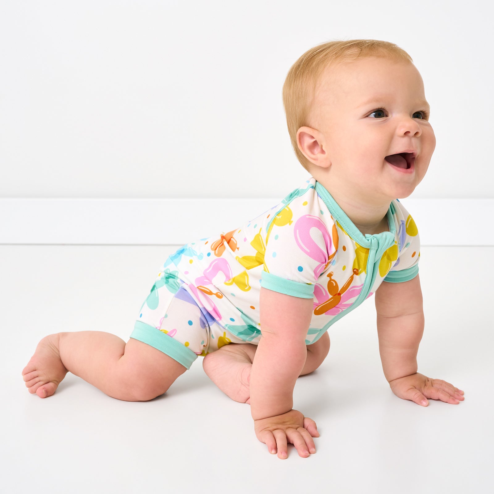 Crawling child wearing the Balloon Bash Shorty Zipper Pjs