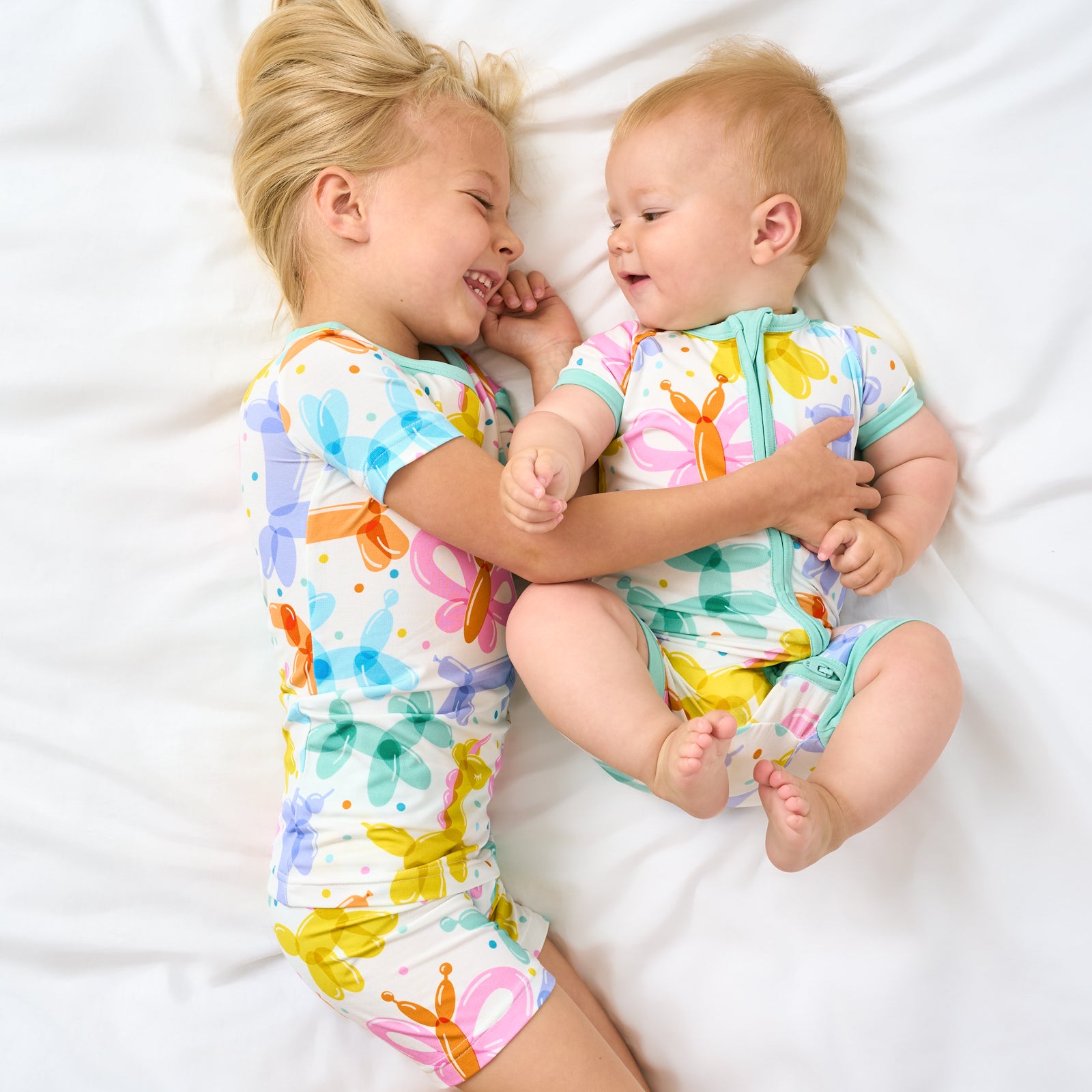 Aerial view of two children wearing matching Balloon Bash pajamas