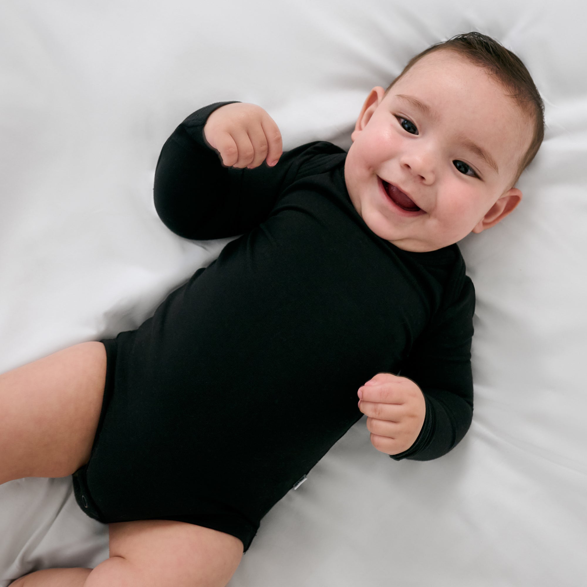 Aerial view of baby wearing the Black Long Sleeve Bodysuit