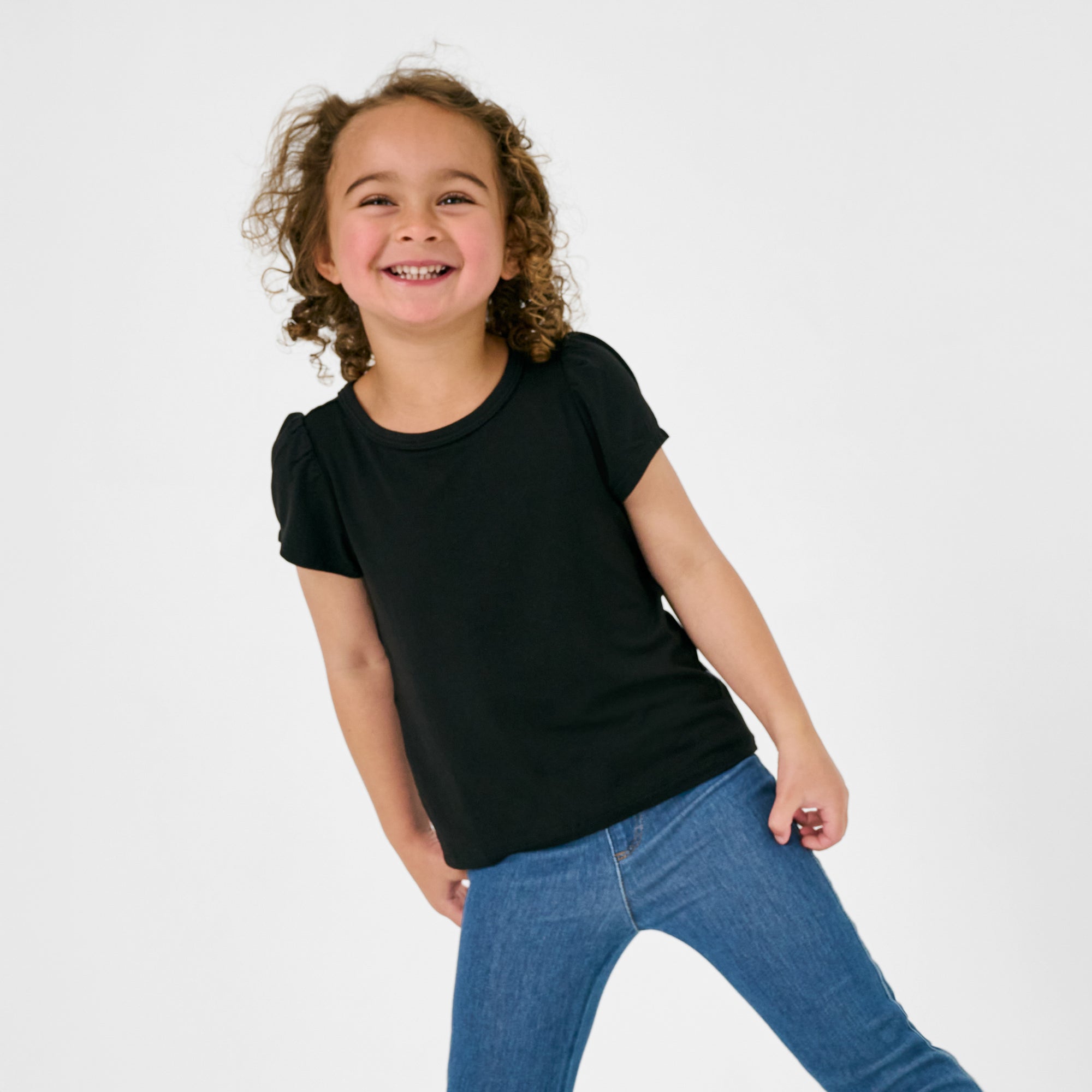 Standing child wearing the Black Puff Sleeve Tee