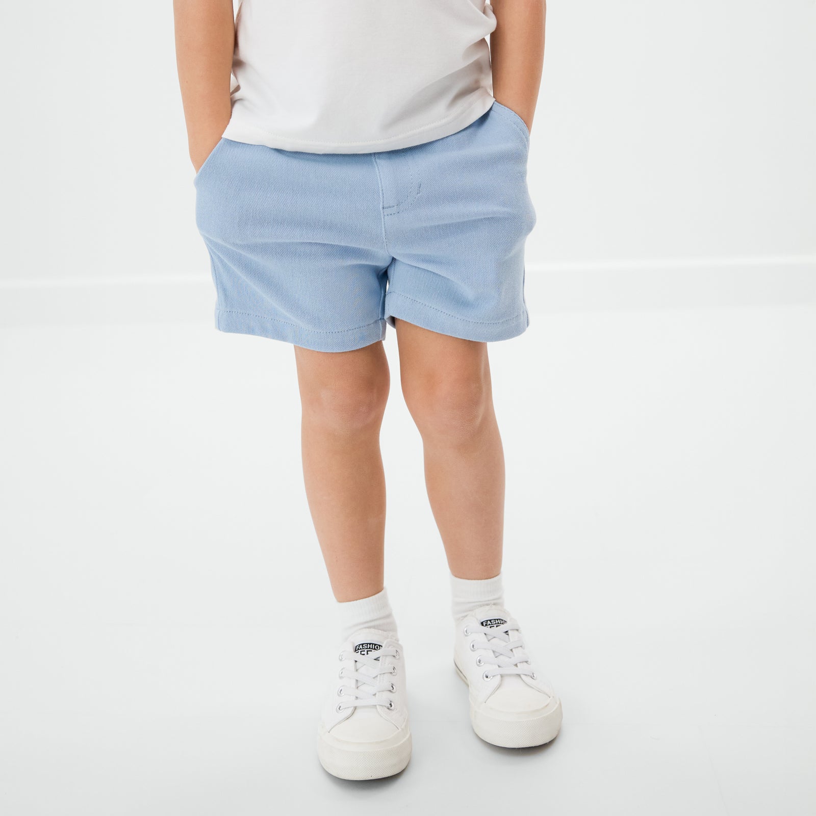 Close up of child wearing the Blue Bliss Chino Shorts with a white bamboo tee