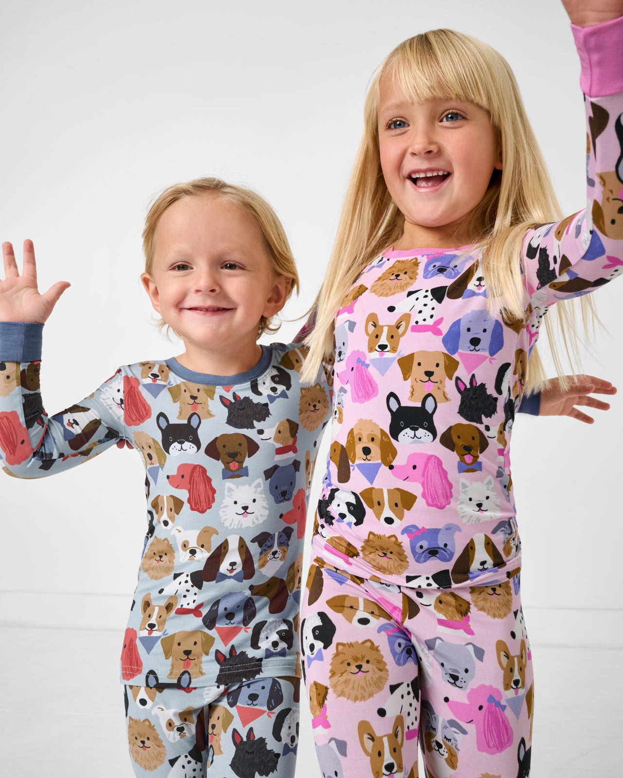 Siblings wearing matching Puppy Parade Two-Piece Pajama Sets