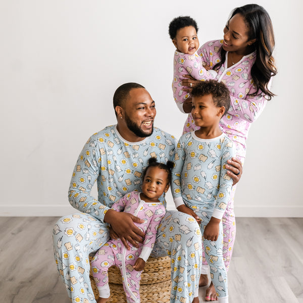Family of five matching in coordinating Blue and Pink breakfast buddies pajamas
