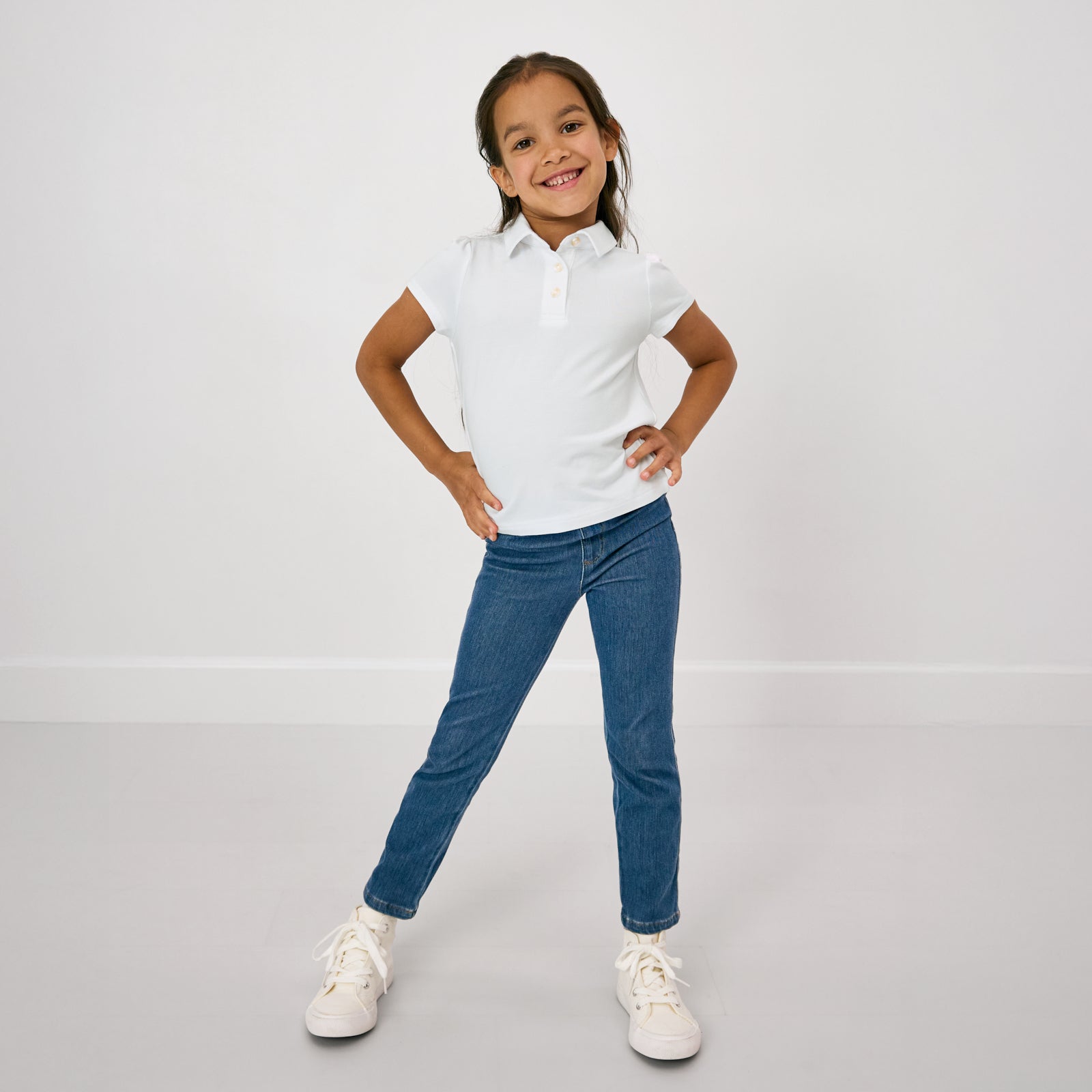 Posing child wearing the Bright White Puff Sleeve Polo