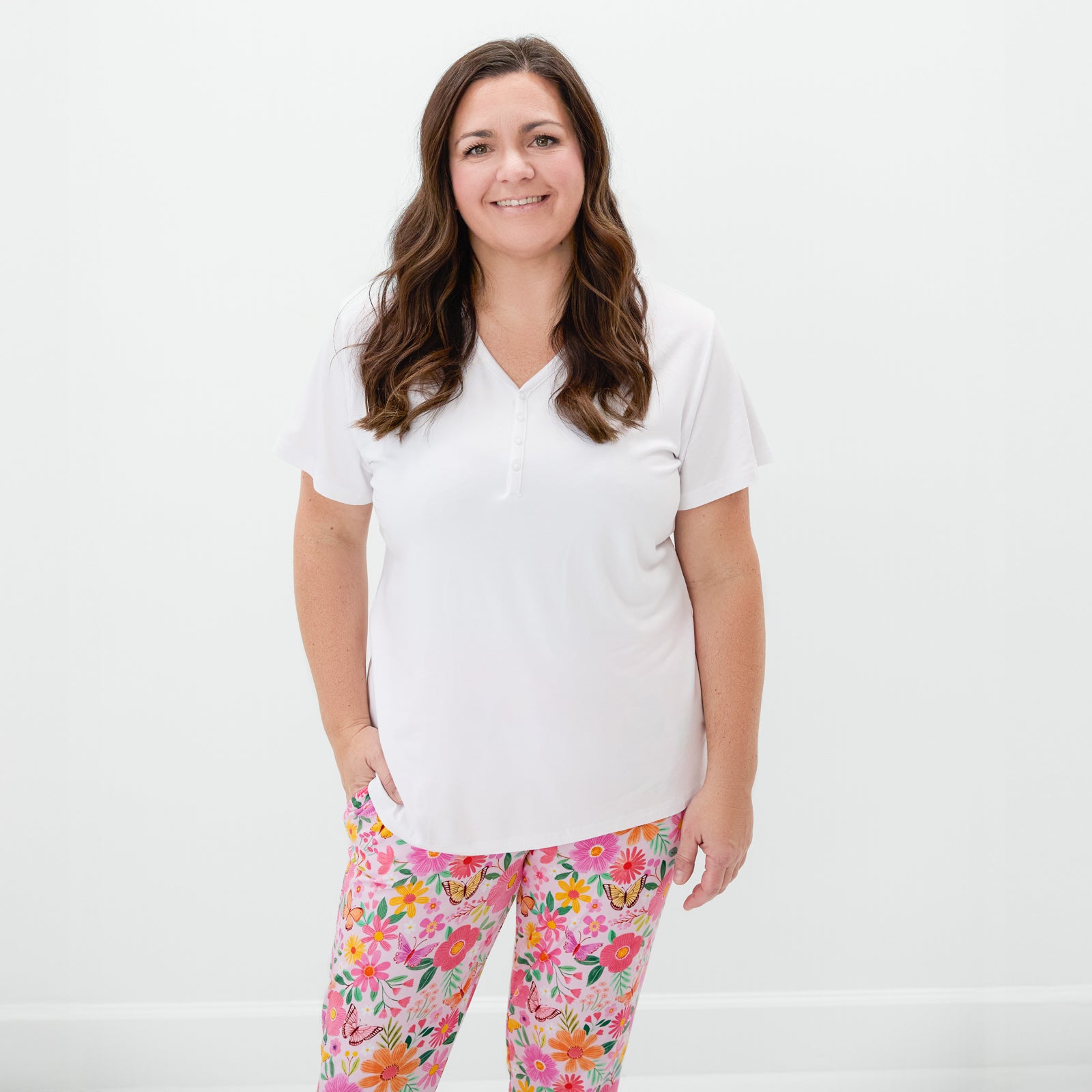 Woman wearing the Bright White Women's Short Sleeve Pajama Top with butterfly blooms pajama pants