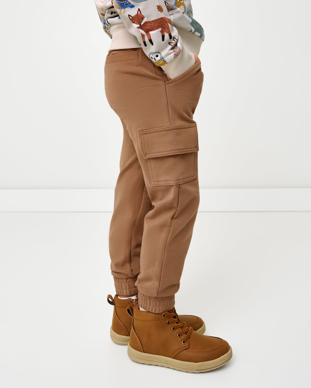 Side view of boy wearing the Caramel Cargo Jogger