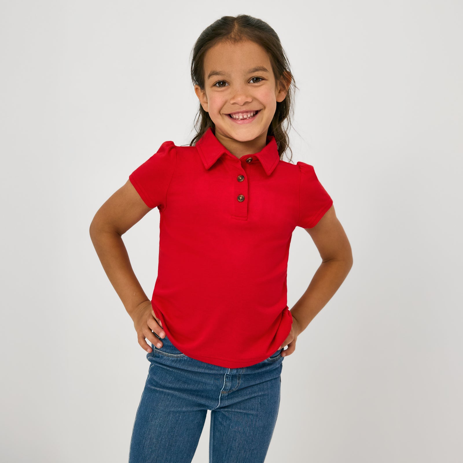 Posing child wearing the Candy Red Puff Sleeve Polo
