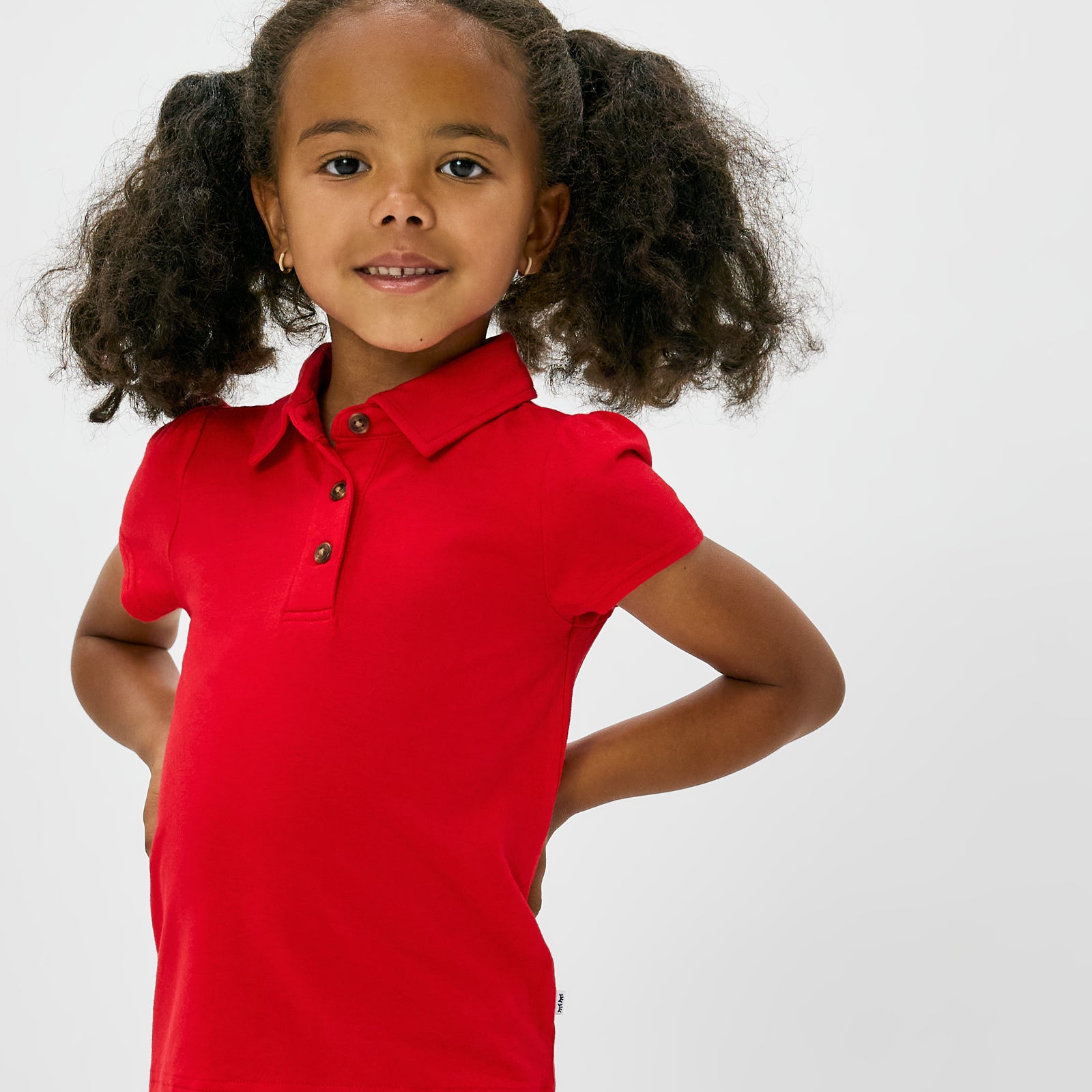 Close up of child wearing the Candy Red Puff Sleeve Polo