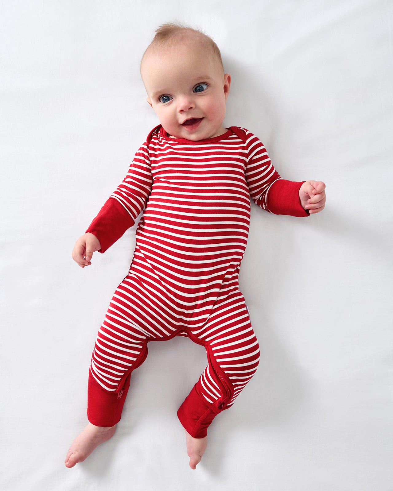 Aerial view of baby wearing the Candy Cane Stripe Crescent Zippy