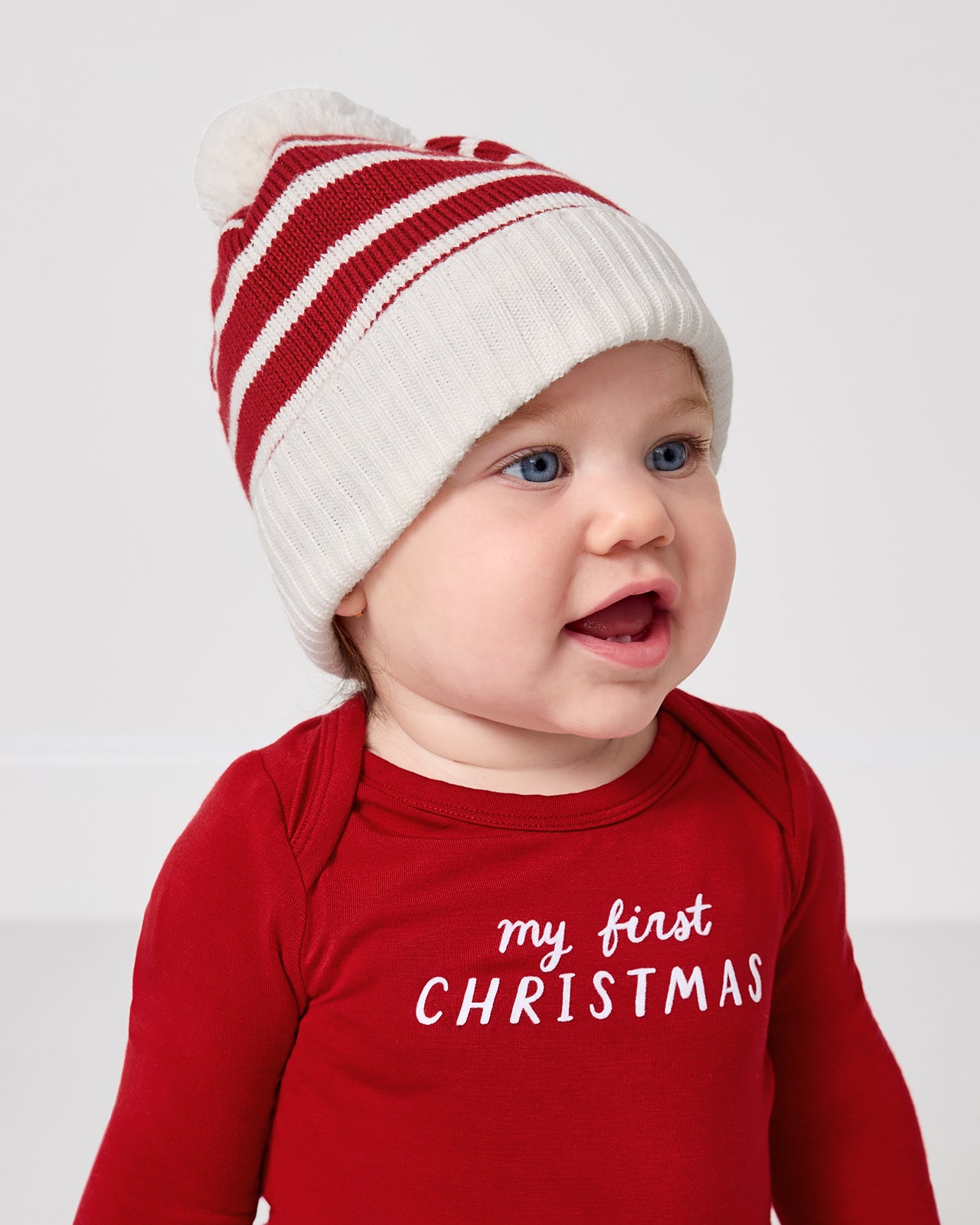 Baby wearing the Candy Cane Stripe Sweater Beanie Hat