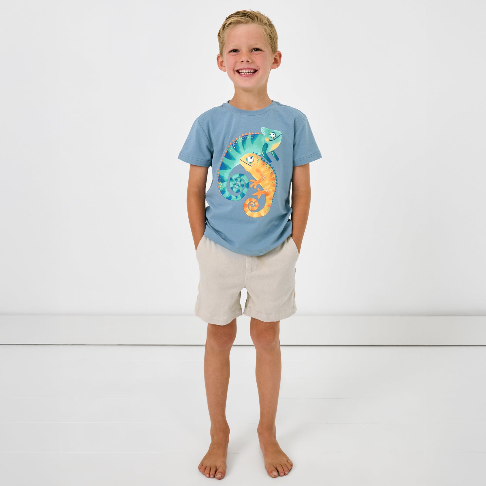 Standing child wearing the Chameleon Relaxed Tee with Bone chino shorts