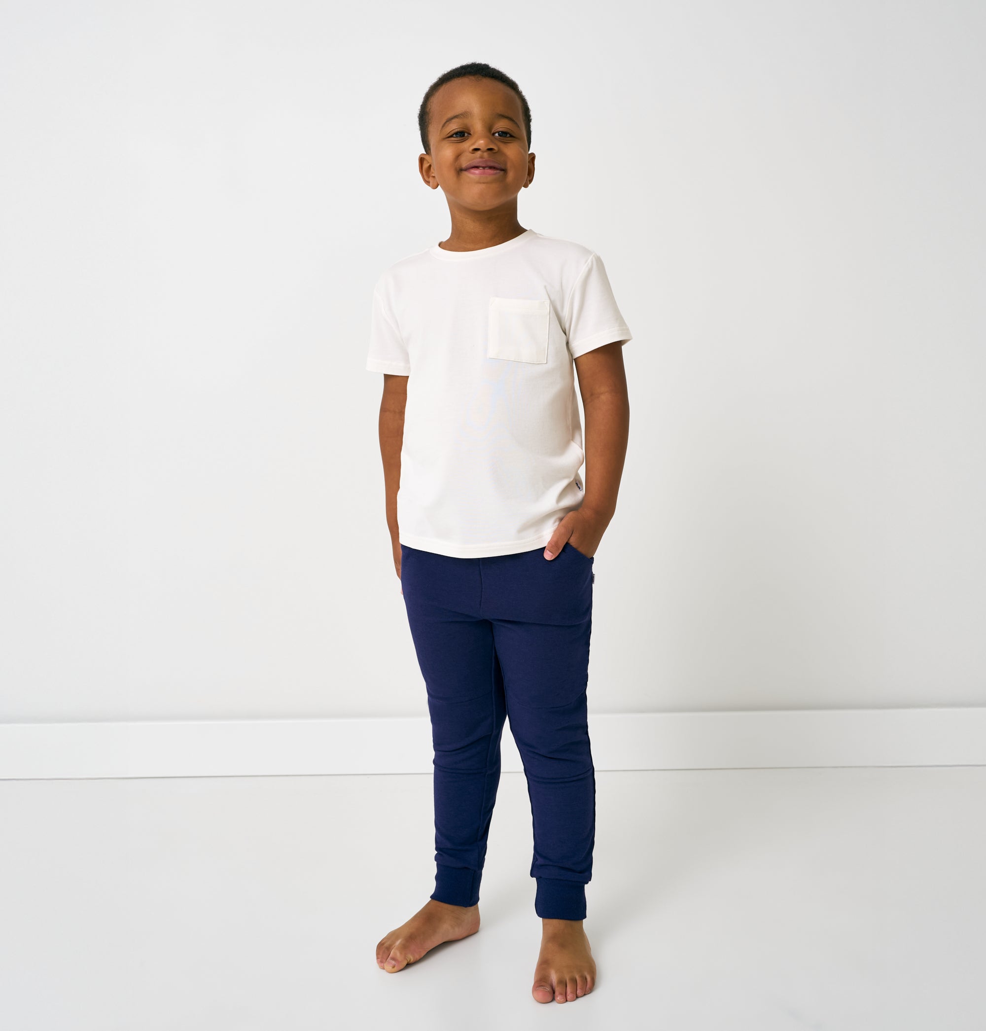 Standing child wearing the Classic Navy Jogger with a white tee
