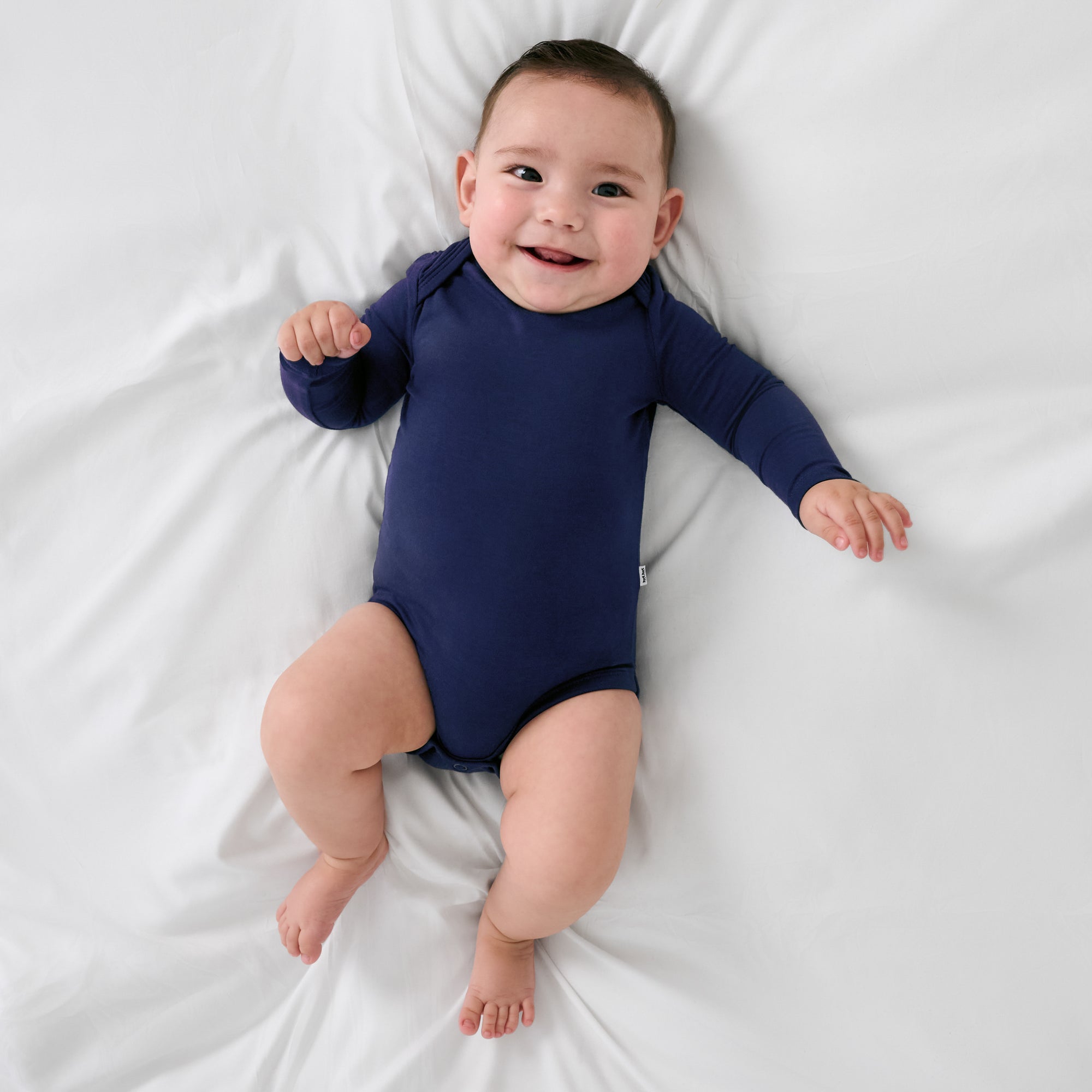 Aerial view of child wearing the Classic Navy Long Sleeve Bodysuit
