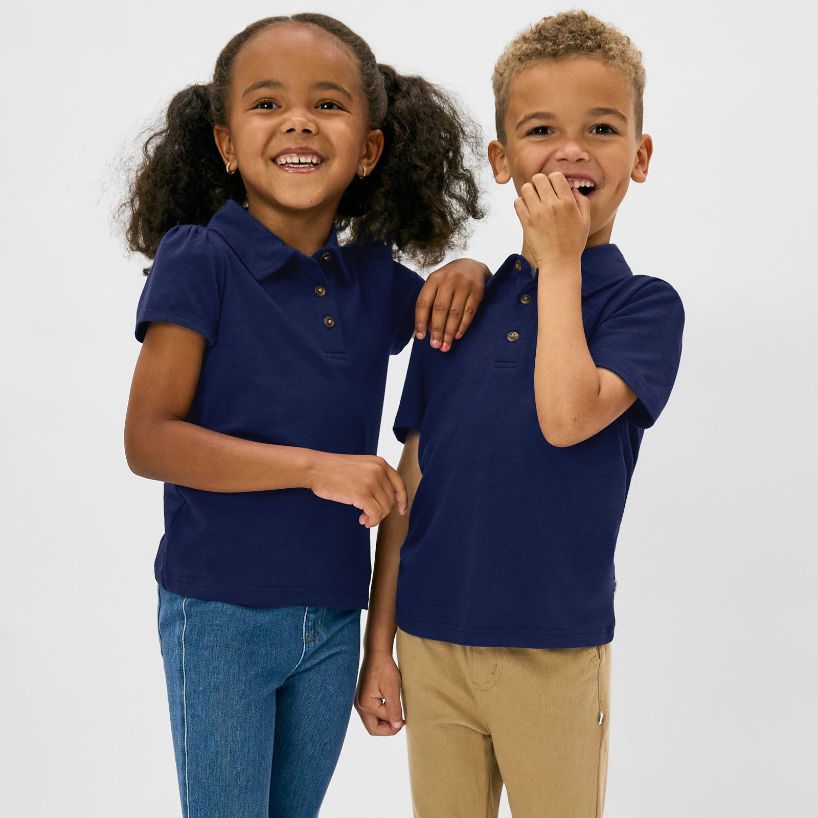 Two children wearing matching Classic Navy Polos