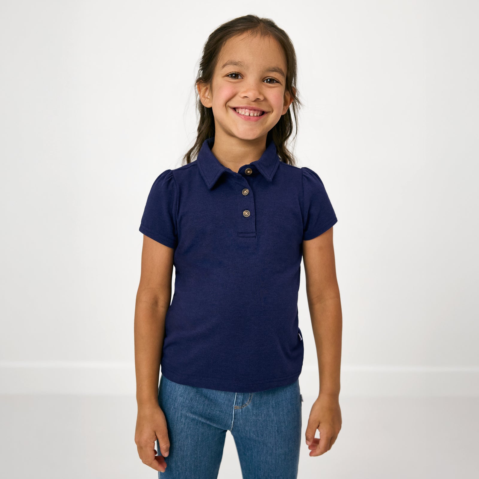 Standing child wearing the Classic Navy Puff Sleeve Polo