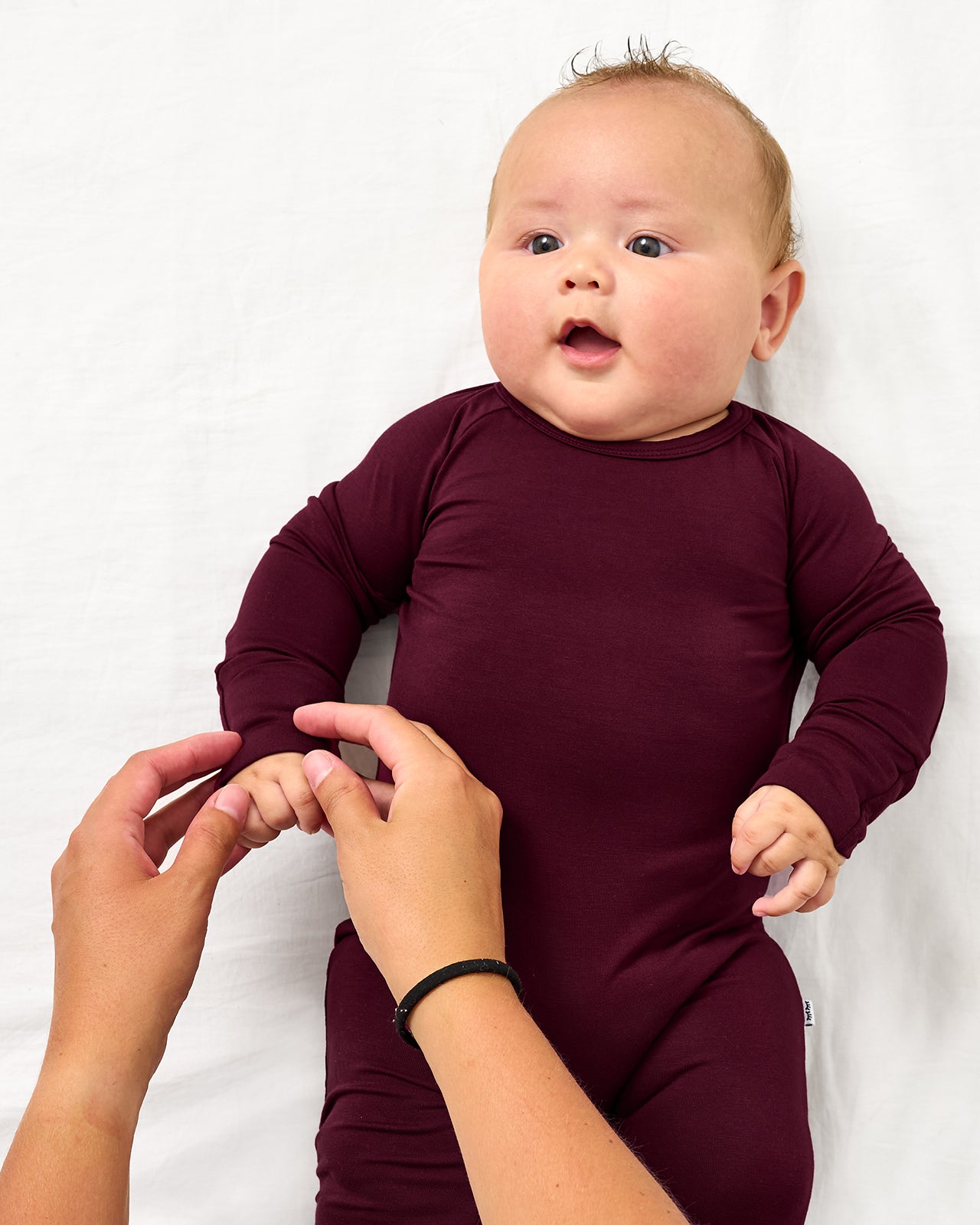 Adult adjusting the hand fold over feature on the Classic Burgundy Crescent Zippy