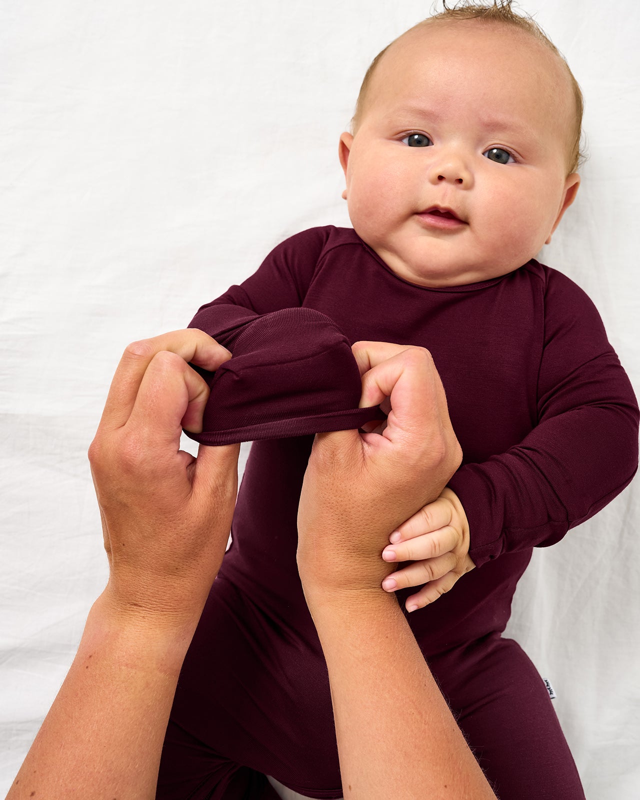 Adult demonstrating the mitten feature on the Classic Burgundy Crescent Zippy