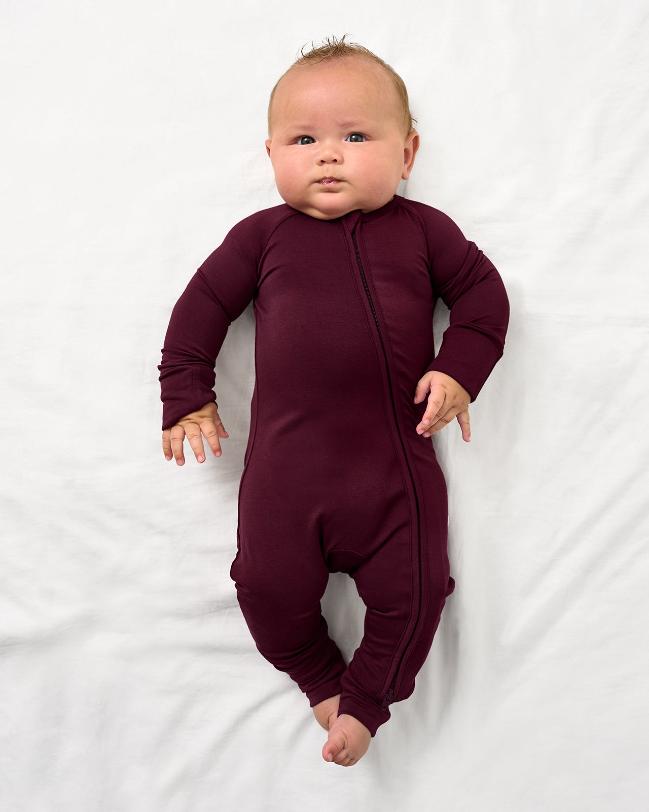 Baby wearing the Classic Burgundy Zippy