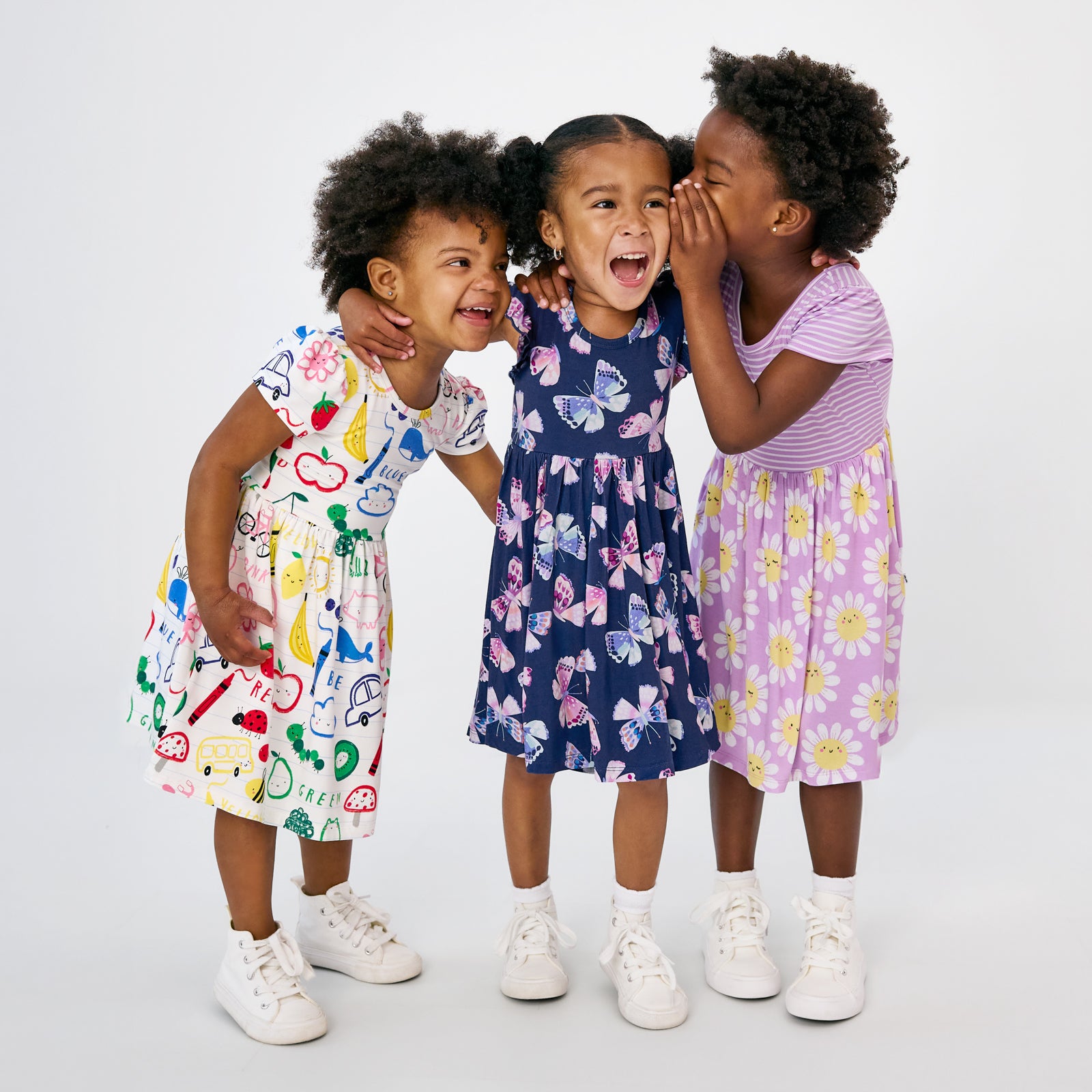 Three children wearing Back to School dresses for girls