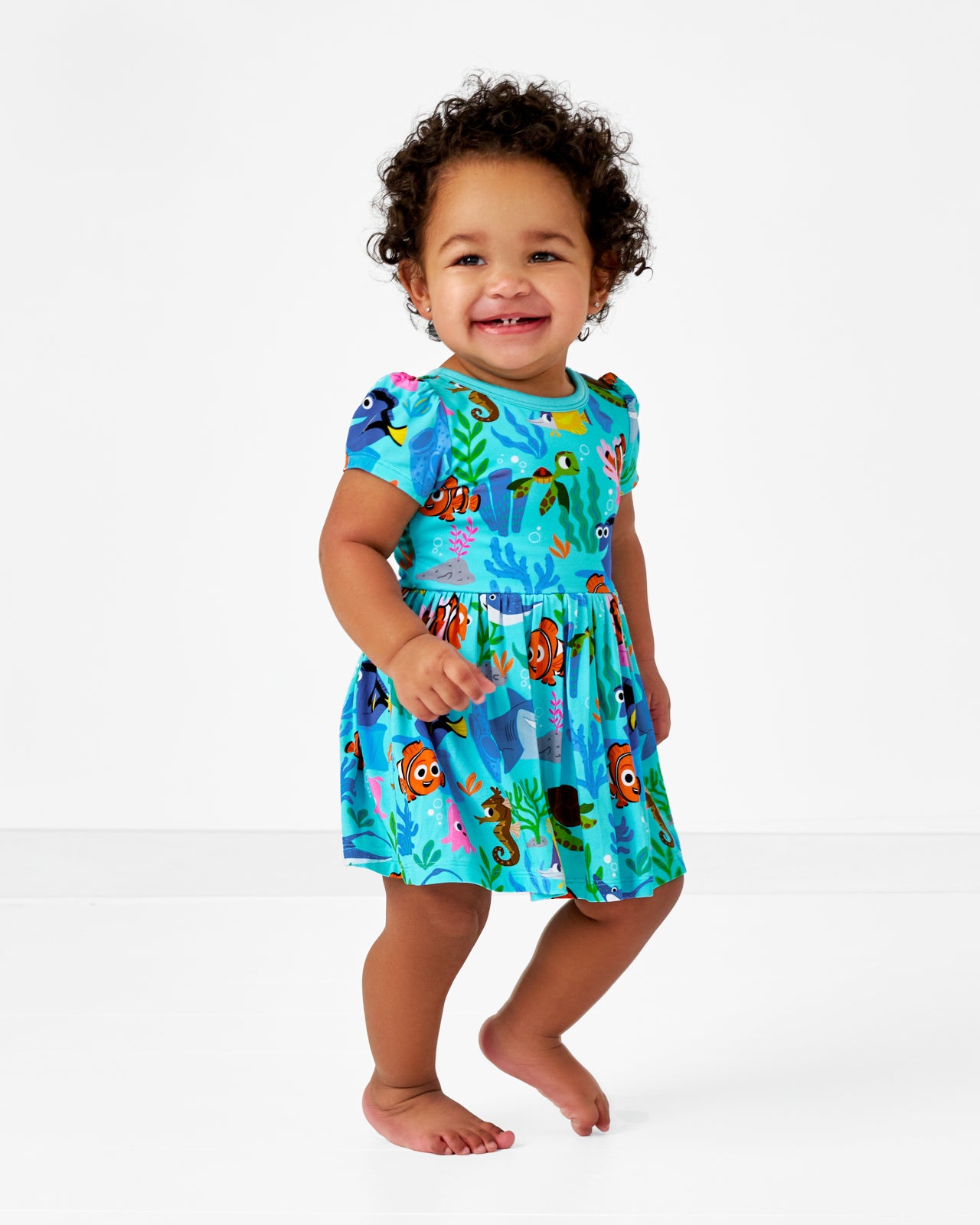 Walking toddler wearing the Disney Nemo's Reef Skater Dress with Bodysuit