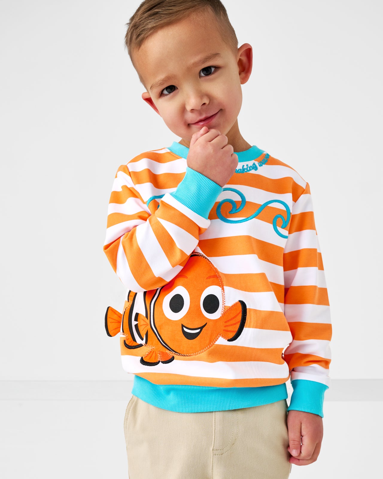Posing child wearing the Disney Nemo Crewneck Sweatshirt