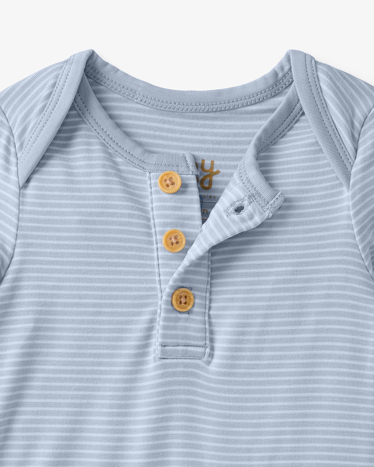 Close up flat lay of the button detail on the Light Fog Stripe Henley Bodysuit