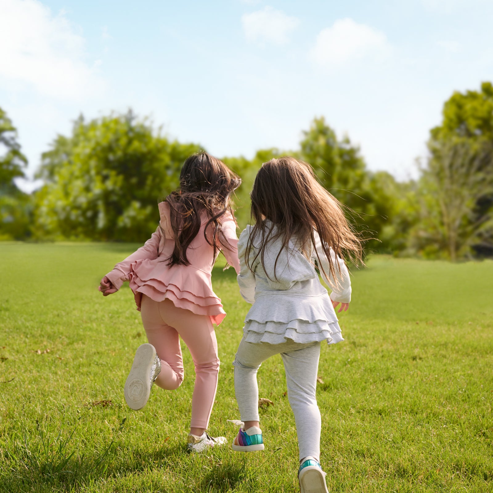 Two running children wearing matching Peplum Hoodies with leggings