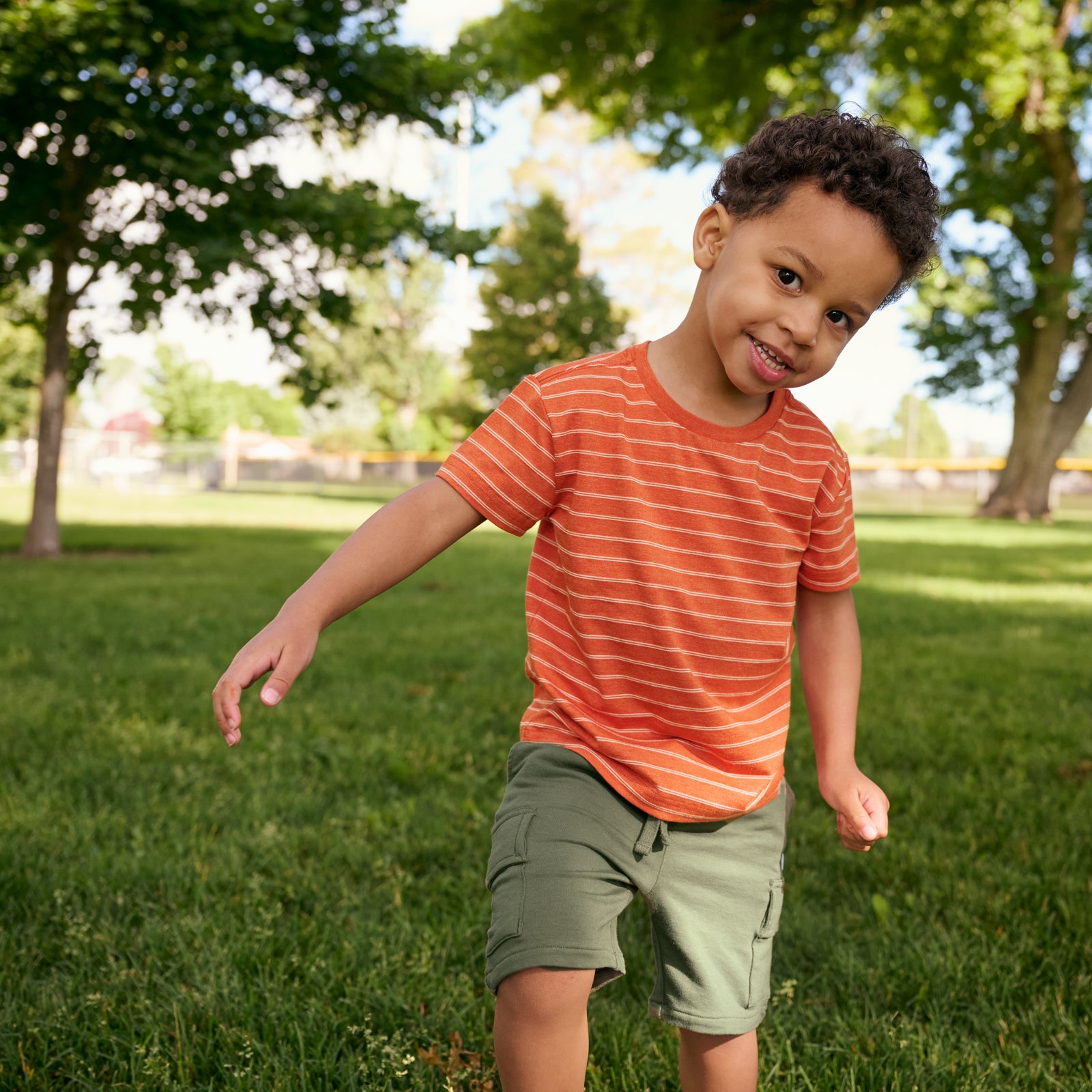 boy wearing rust stripes tee and Olive Cargo Shorts