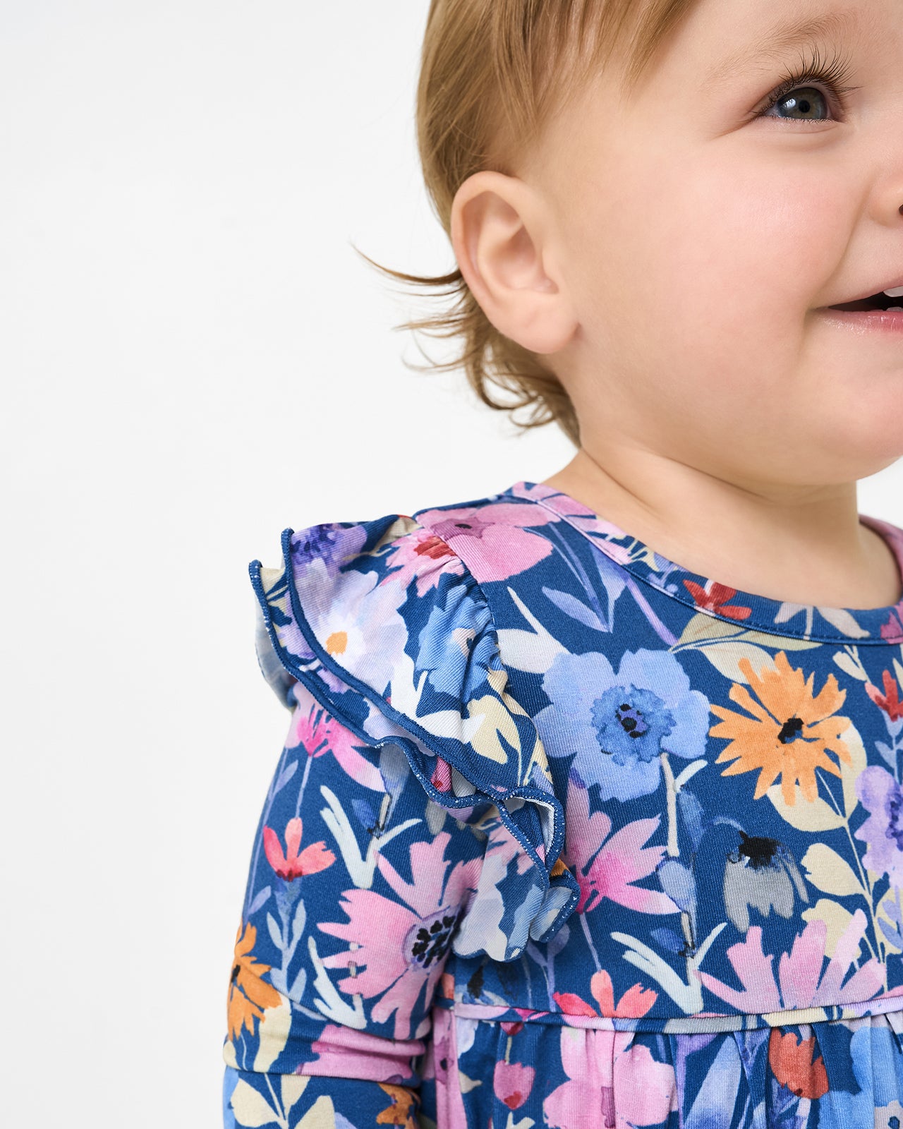 Close up of the ruffle shoulder detail on the Dusk Blooms Bubble Romper