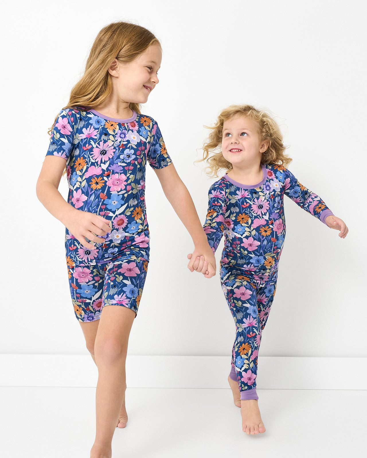 Two girls wearing matching Dusk Blooms Two-Piece Short Pajama Sets