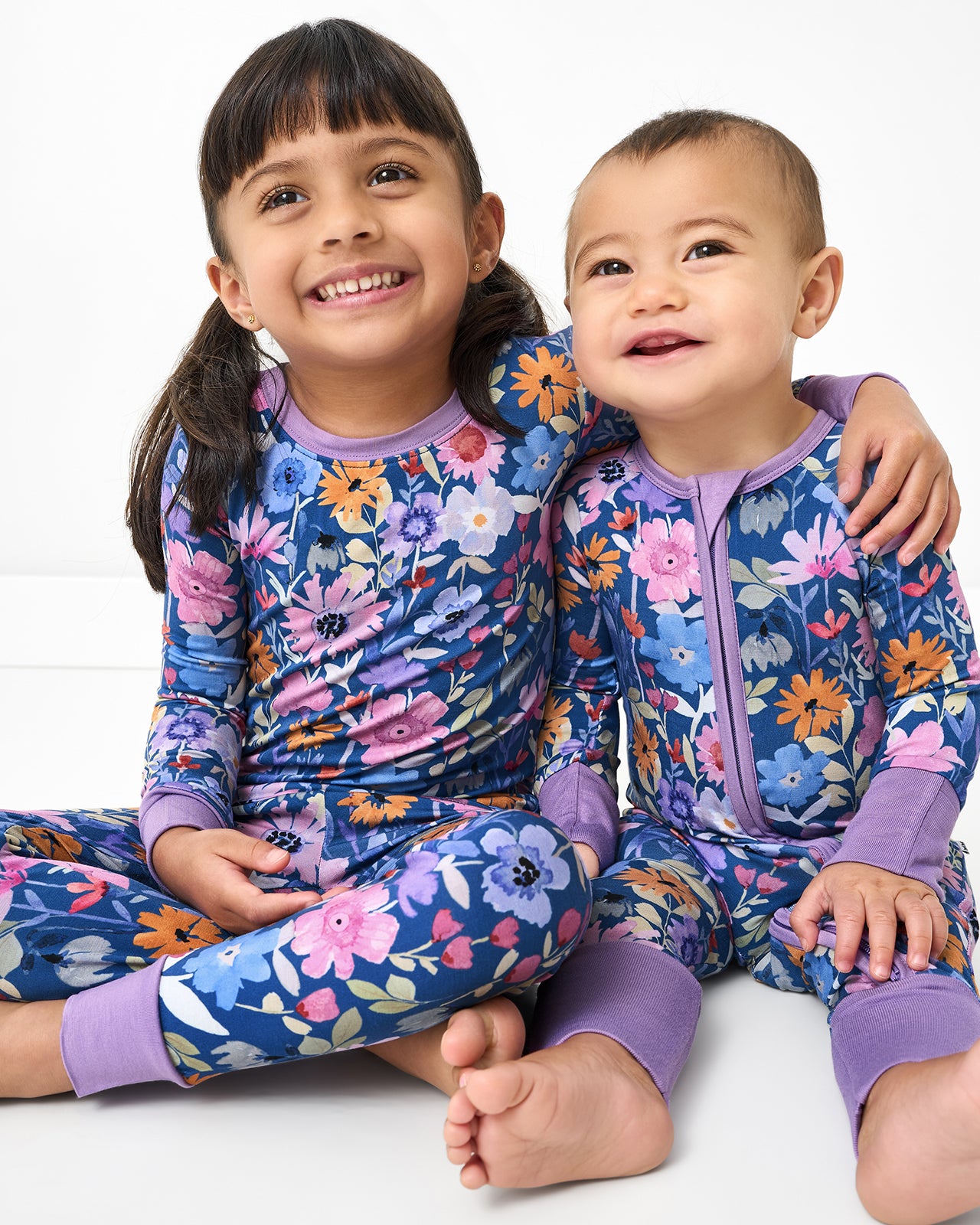Two children wearing Dusk Blooms bamboo floral pajamas