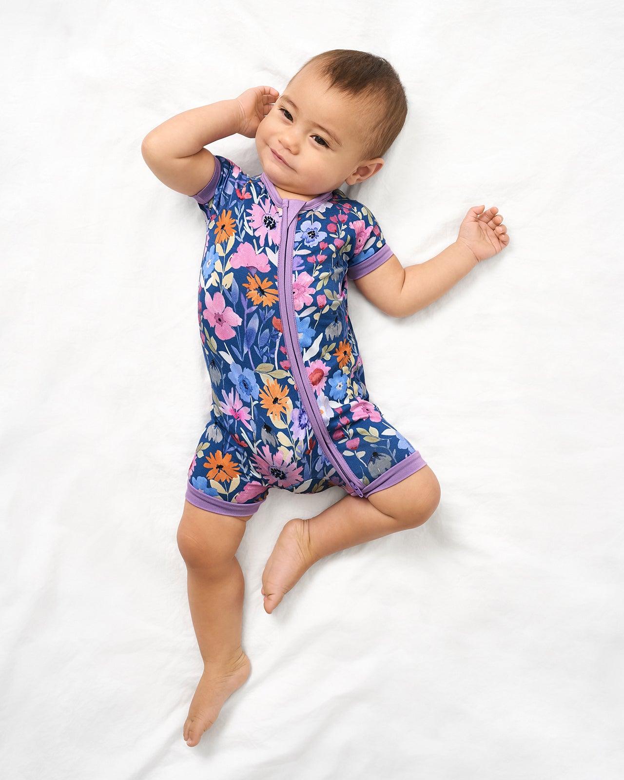Aerial view of baby wearing the Dusk Blooms Shorty Zippy