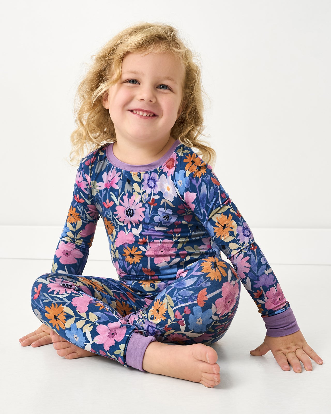 Sitting girl wearing the Dusk Blooms Two-Piece Pajama Set