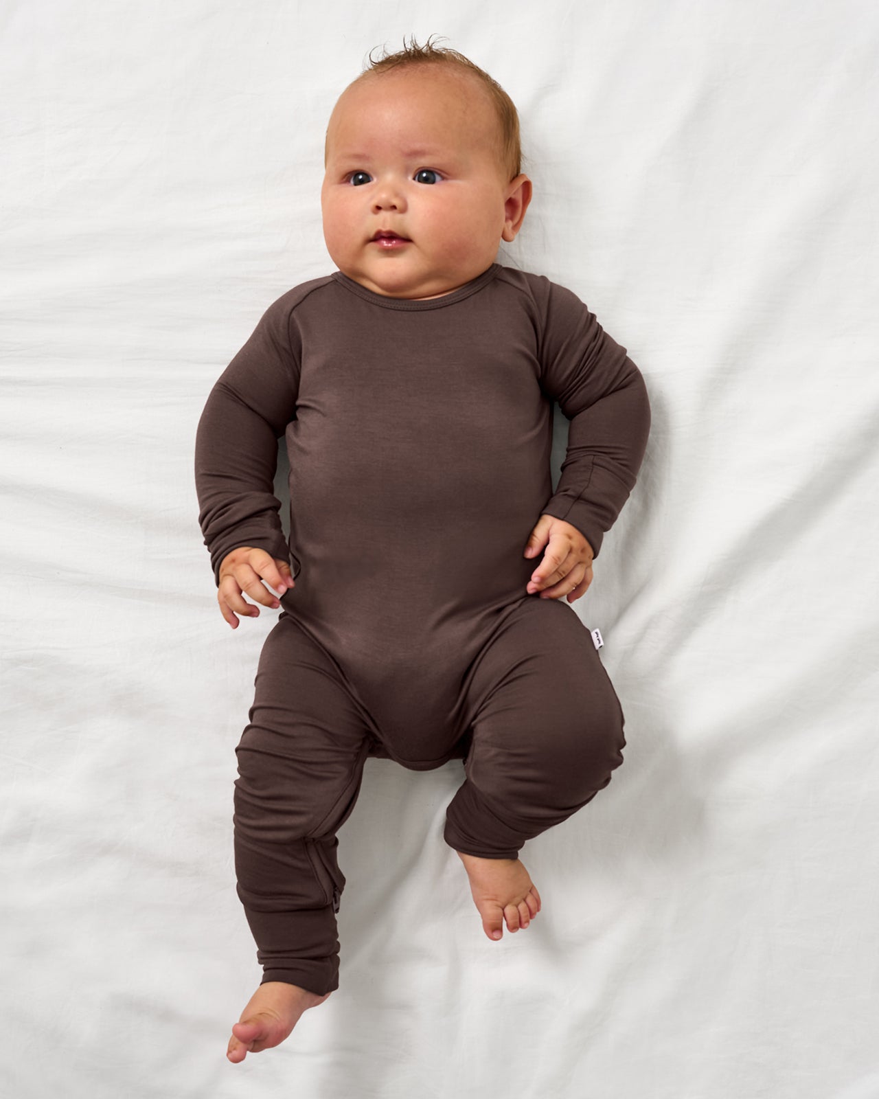 Alternate aerial view of baby wearing the Dark Chocolate Crescent Zippy