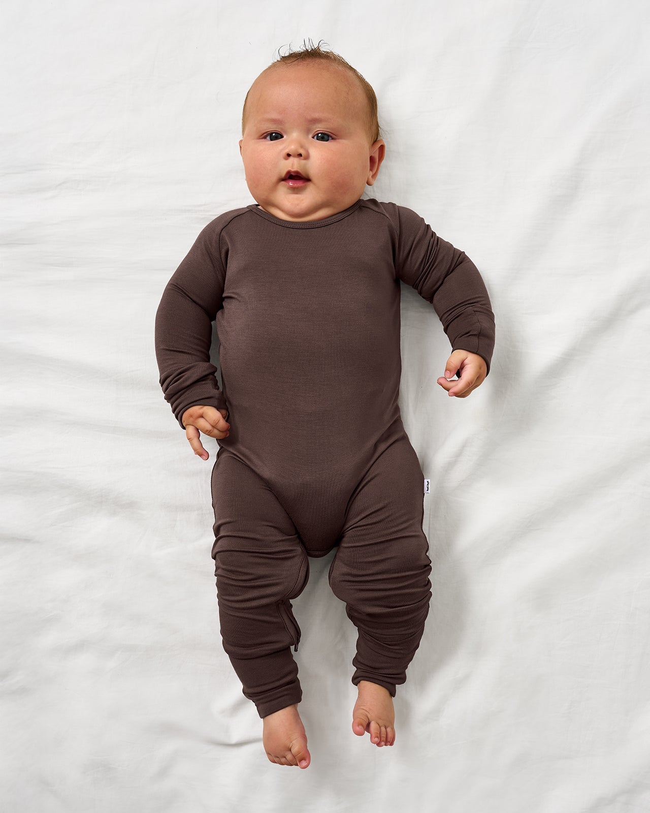 Aerial view of baby wearing the Dark Chocolate Crescent Zippy