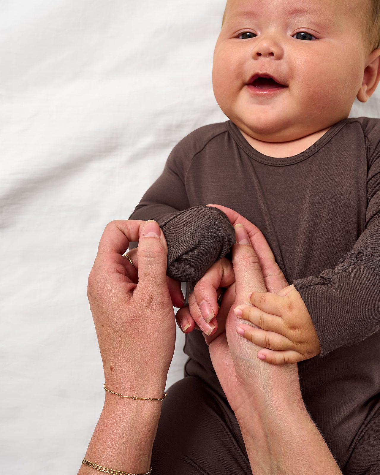 Adult demonstrating the mitten feature on the Dark Chocolate Crescent Zippy