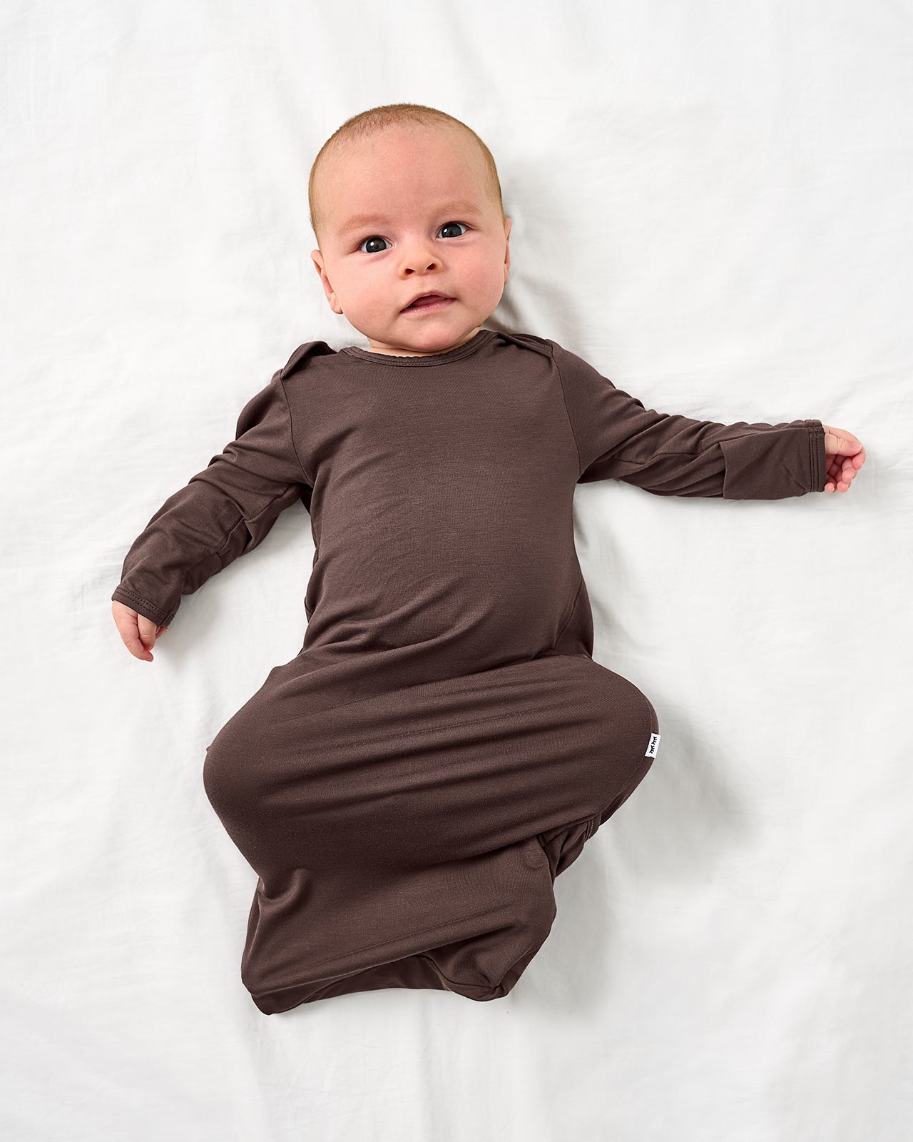 Alternate aerial view of baby wearing the Dark Chocolate Infant Gown