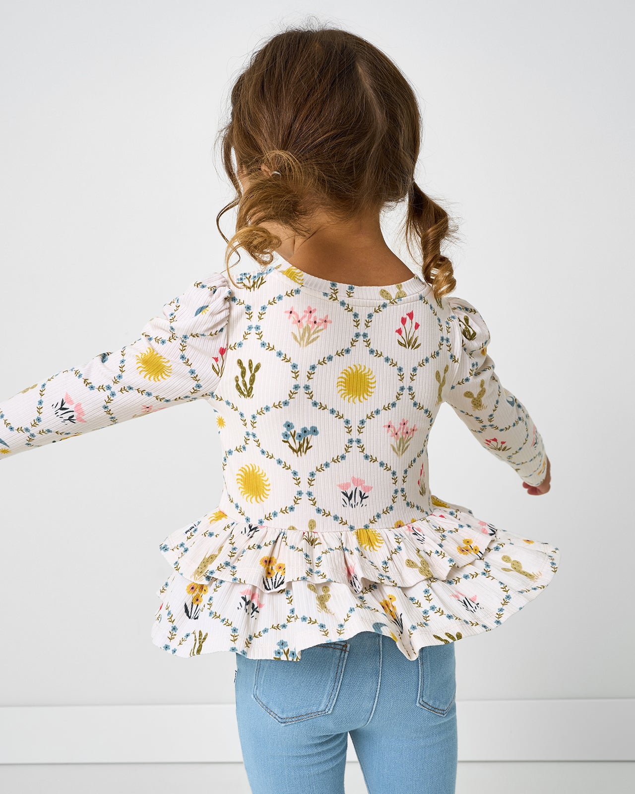 Twirling girl wearing the Desert Meadow Ribbed Tiered Peplum Top