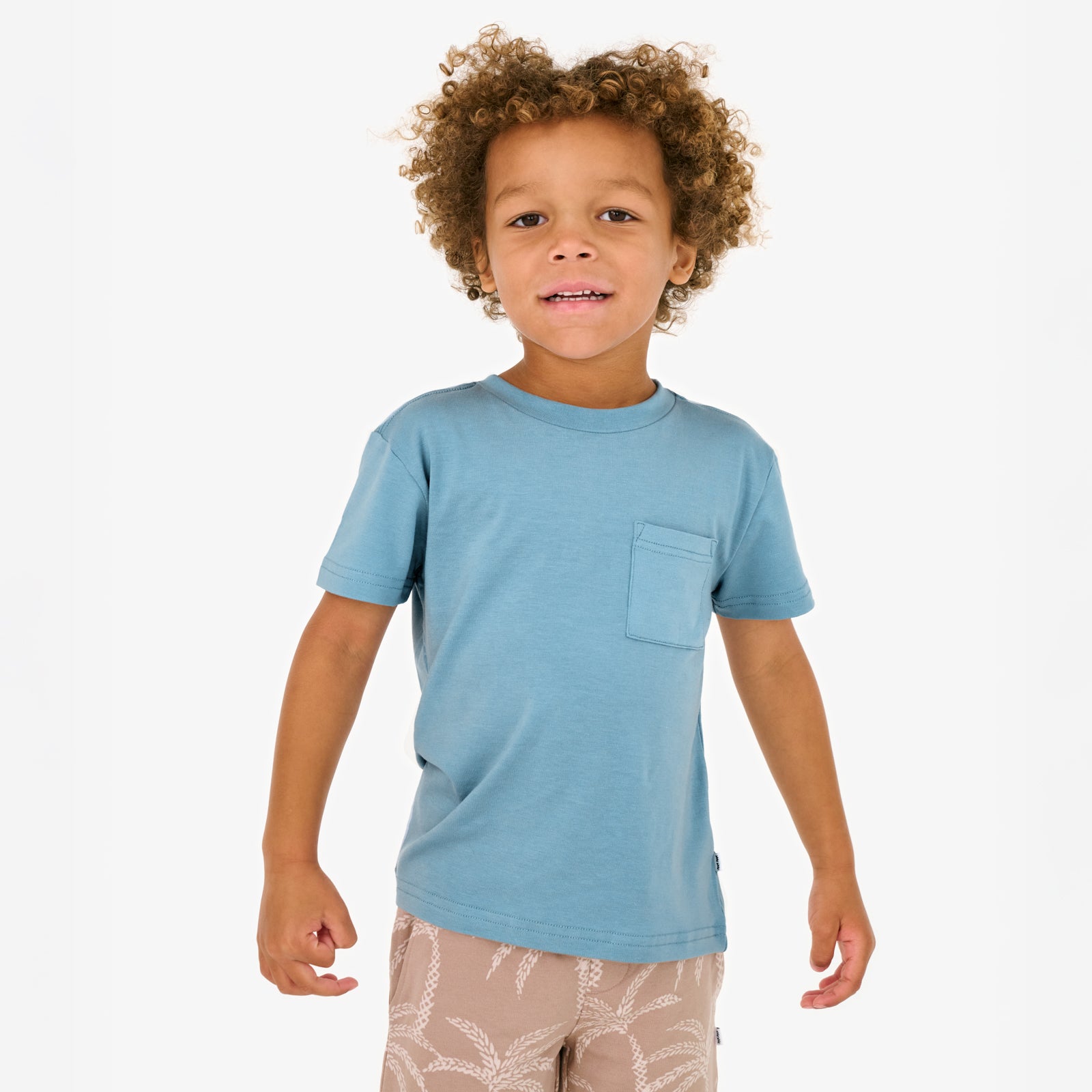 Standing child wearing the Dusk Blue Relaxed Pocket Tee